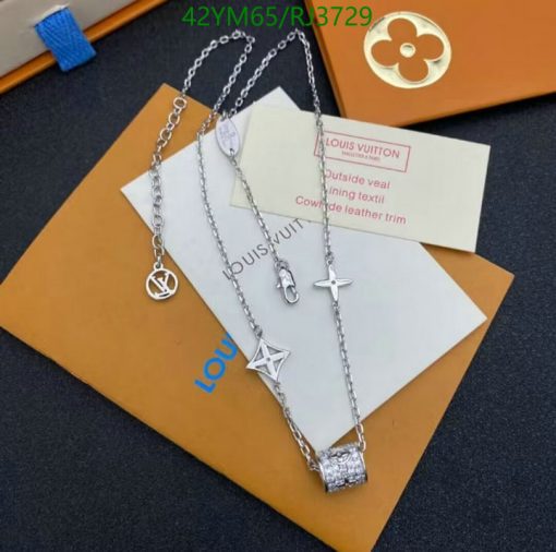 Designer silver necklaces on branded packaging.