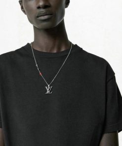 Man wearing black shirt with silver necklace.