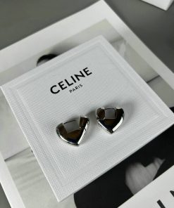 Designer silver heart-shaped earrings on display.