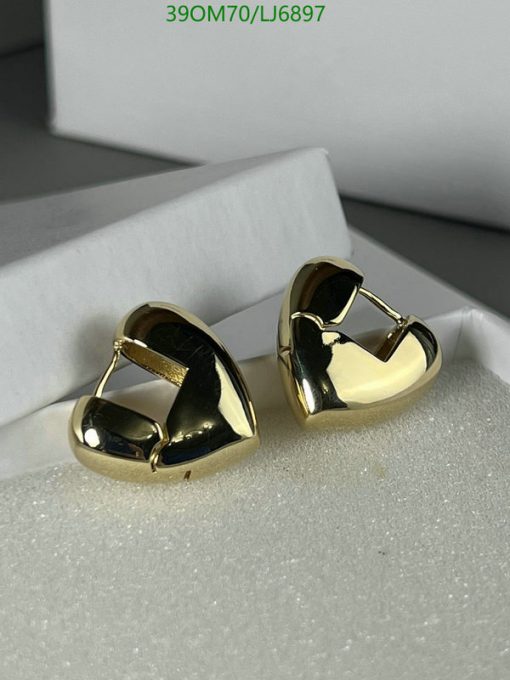 Gold hoop earrings on white display.