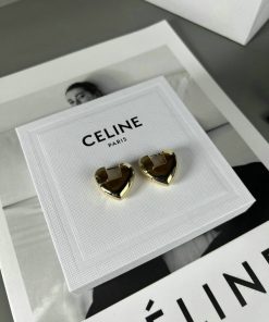 Celine Paris gold heart-shaped earrings on display.