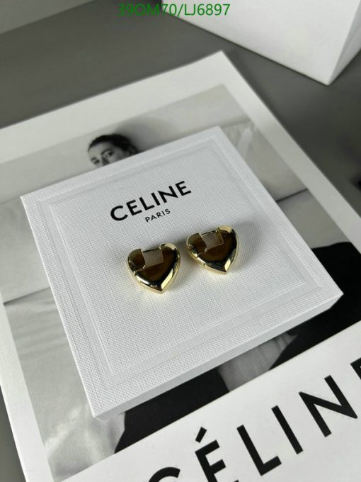 Celine Paris gold heart-shaped earrings on display.