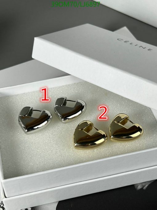 Silver and gold heart-shaped earrings in box.