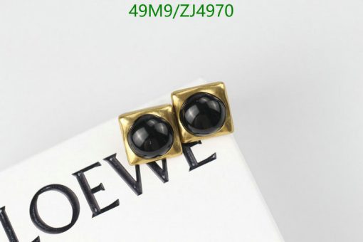 Gold square cufflinks with black centers on white background.