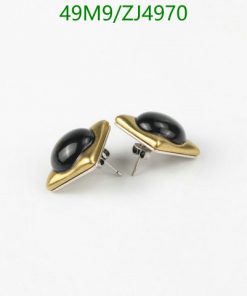 Gold and black oval cufflinks on white background.