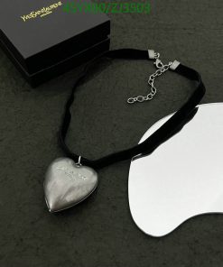 Silver heart pendant on black ribbon with box.