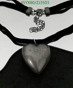 Silver heart pendant on black velvet ribbon.