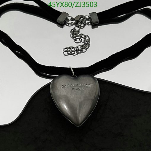 Silver heart pendant on black velvet ribbon.