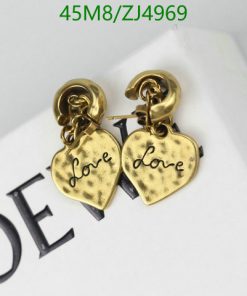 Gold heart-shaped "love" earrings on white surface.