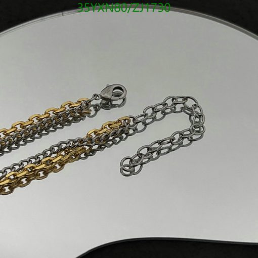 Silver and gold chains on white background.