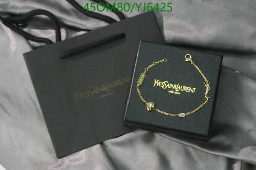 Designer bracelet in box with brand shopping bag.