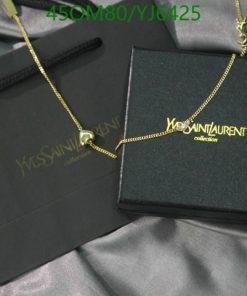 Designer necklace with box on satin fabric.