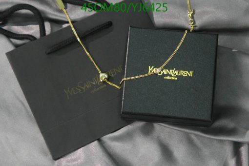 Designer necklace with box on satin fabric.