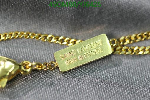 Gold Saint Laurent label on chain necklace.