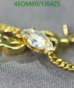 Gold necklace with marquise diamond pendant.