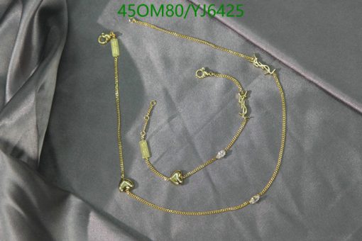 Gold jewelry set on satin fabric.