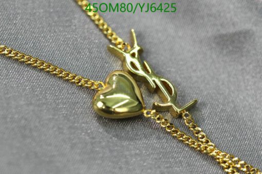 Gold heart pendant on chain with airplane charm.