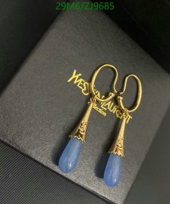 Gold and blue earrings on black case.