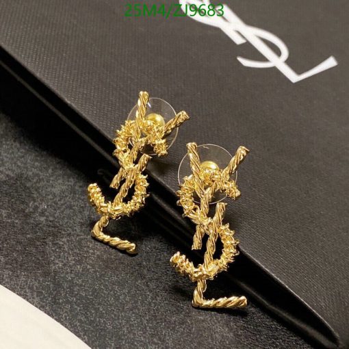 Gold twisted rope bunny earrings on black background.