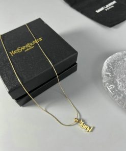 Yves Saint Laurent necklace with box on white surface.