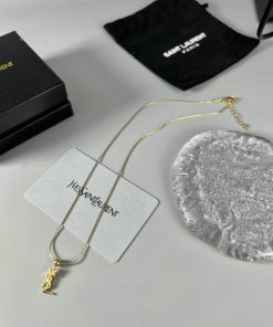 Gold necklace with logo pendant and elegant packaging.