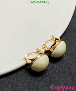 Gold clip-on earrings with white stones.