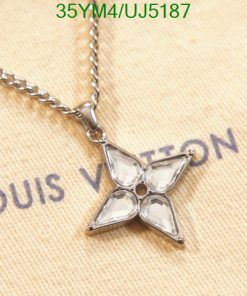 Designer star-shaped pendant necklace on fabric.