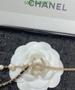 Chanel pearl bracelet on white flower display