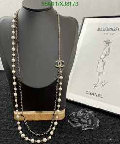 Elegant pearl necklace with logo pendant on mannequin.