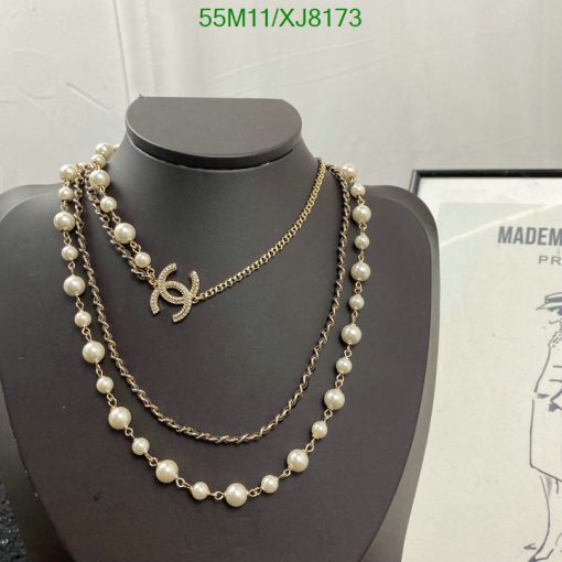 Elegant pearl and chain necklace on display mannequin.