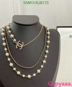 Pearl necklace and chain on mannequin display.