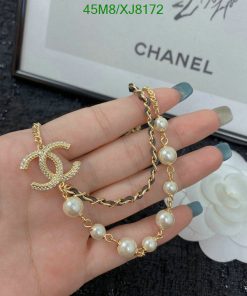 Gold pearl bracelet with decorative charm.