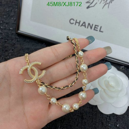 Gold pearl bracelet with decorative charm.