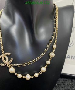 Gold chain necklace with pearls on mannequin.