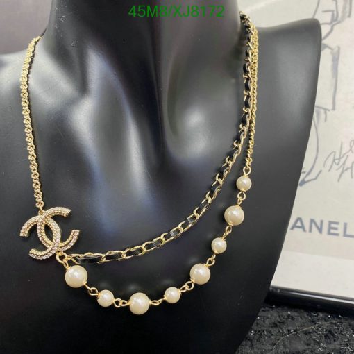 Gold chain necklace with pearls on mannequin.