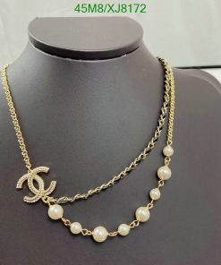 Elegant pearl and gold chain necklace on mannequin.