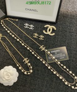 Chanel jewelry set with pearls and logo displayed.