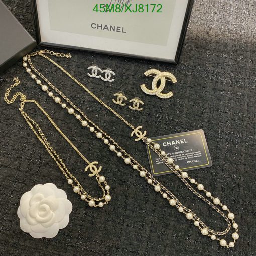 Chanel jewelry set with pearls and logo displayed.