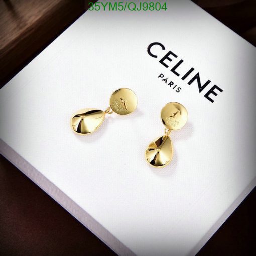 Gold drop earrings on white branded box.