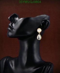 Elegant earring on black mannequin bust.