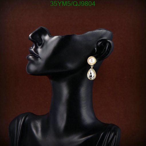 Elegant earring on black mannequin bust.