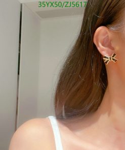 Woman wearing star-shaped earring.