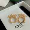 Gold Celine hoop earrings on white box.