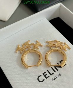 Gold Celine hoop earrings on white box.