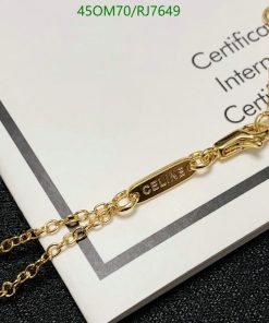 Gold "CELINE" branded necklace on certificate background.