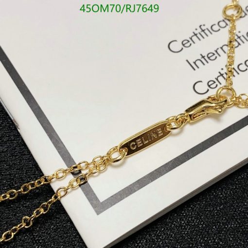 Gold "CELINE" branded necklace on certificate background.