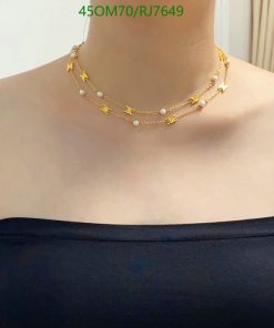 Elegant layered pearl and gold necklaces.