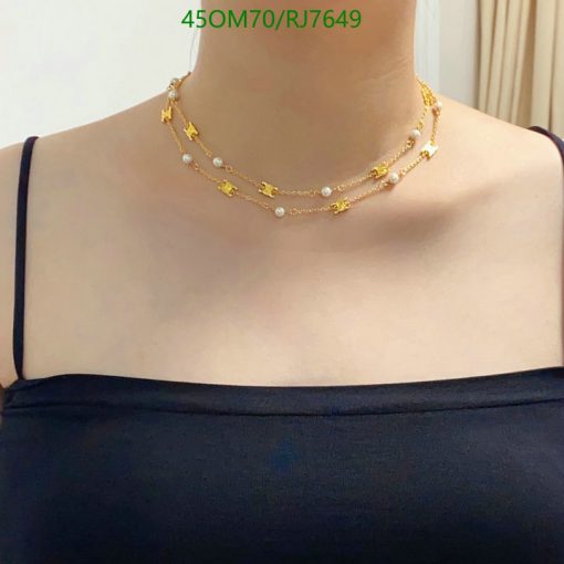 Elegant layered pearl and gold necklaces.