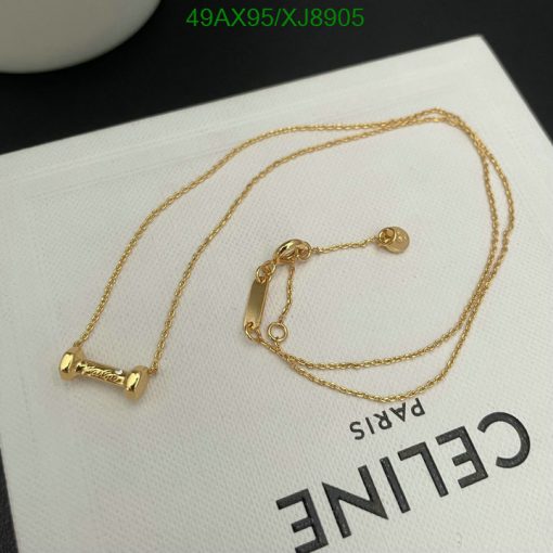 Gold barbell necklace on white surface.