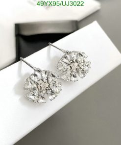 Crystal snowflake earrings on white display.